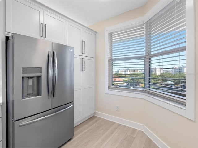 7979 Sailboat Key Blvd S Unit 505, South Pasadena, FL 33707 - kitchen with stainless steel refrigerator with ice dispenser, light wood-style floors, and white cabinets
