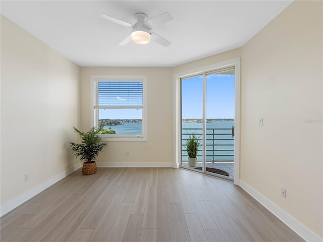 7979 Sailboat Key Blvd S Unit 505, South Pasadena, FL 33707 - empty room with light wood finished floors, a water view, and ceiling fan