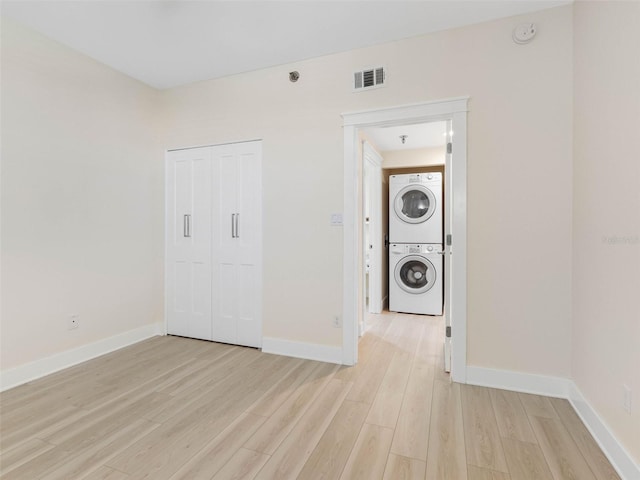 7979 Sailboat Key Blvd S Unit 505, South Pasadena, FL 33707 - washroom featuring stacked washer / drying machine and light wood finished floors