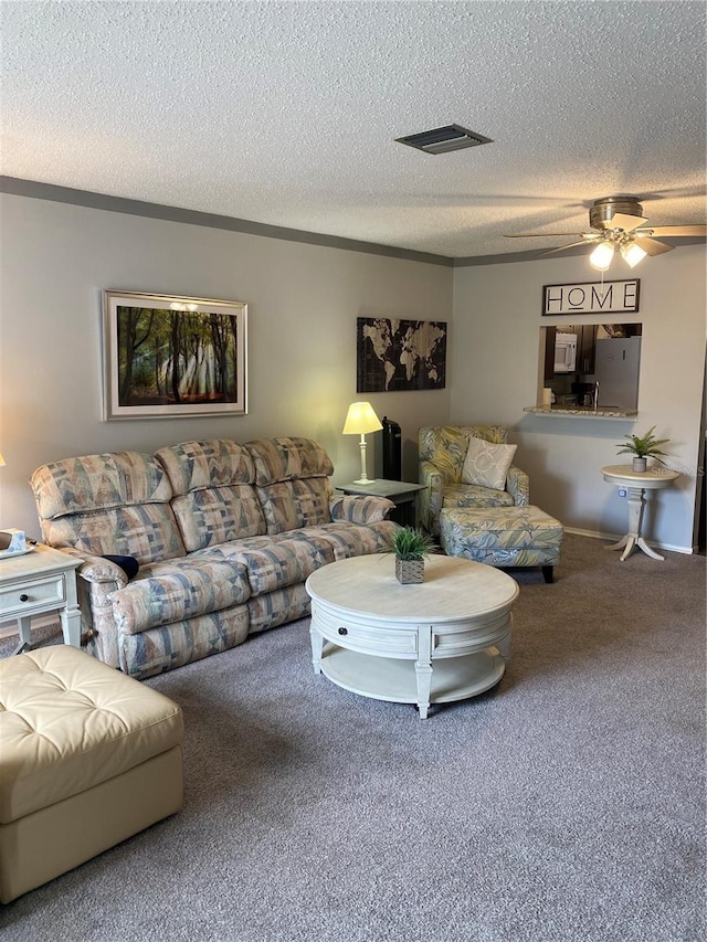 832 Cambridge Ct, Dunedin, FL 34698 - carpeted living area featuring ceiling fan and a textured ceiling