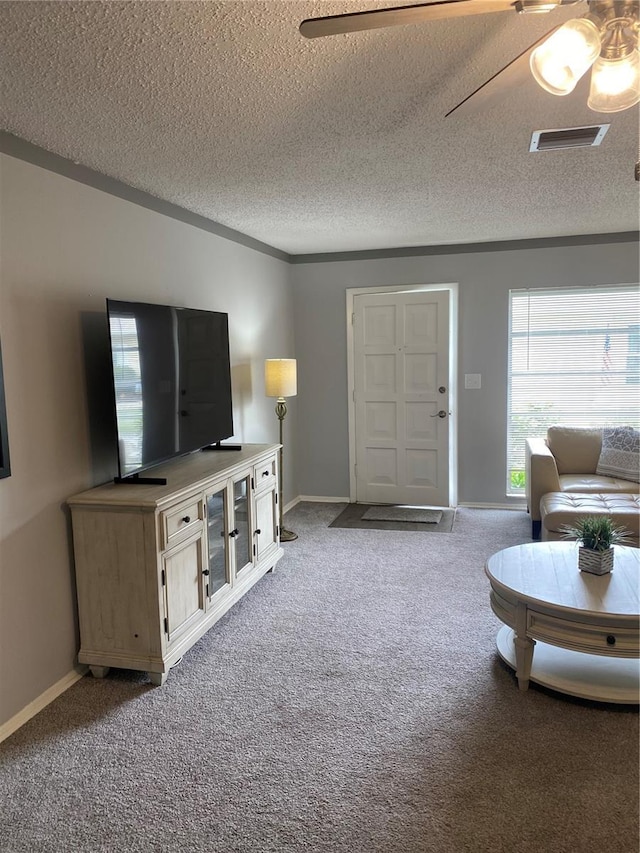 832 Cambridge Ct, Dunedin, FL 34698 - carpeted living room with a textured ceiling and a ceiling fan