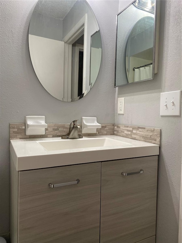 832 Cambridge Ct, Dunedin, FL 34698 - bathroom featuring vanity and decorative backsplash