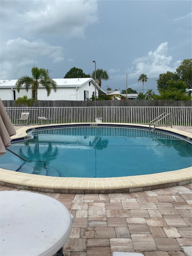 832 Cambridge Ct, Dunedin, FL 34698 - community pool with a fenced backyard