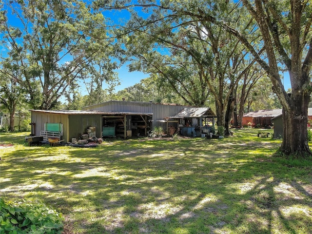 1753 Ranchette Rd, Wesley Chapel, FL 33543 - view of grassy yard with a pole building and an outbuilding