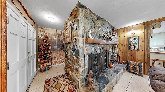 1753 Ranchette Rd, Wesley Chapel, FL 33543 - wine area featuring tile patterned floors, wooden walls, a fireplace, and a textured ceiling
