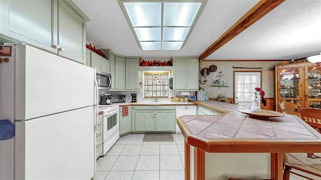 1753 Ranchette Rd, Wesley Chapel, FL 33543 - kitchen featuring white appliances, wallpapered walls, tile countertops, light tile patterned floors, and a peninsula