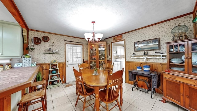 1753 Ranchette Rd, Wesley Chapel, FL 33543 - dining area featuring crown molding, wainscoting, a chandelier, light tile patterned floors, and separate washer and dryer