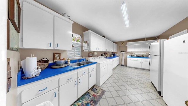 1753 Ranchette Rd, Wesley Chapel, FL 33543 - kitchen featuring freestanding refrigerator, white cabinets, light countertops, and washer and dryer
