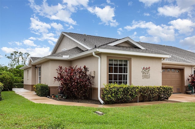 1626 Terra Ceia Bay Cir Unit 1626, Palmetto, FL 34221 - view of side of home featuring an attached garage, stucco siding, a shingled roof, and a yard