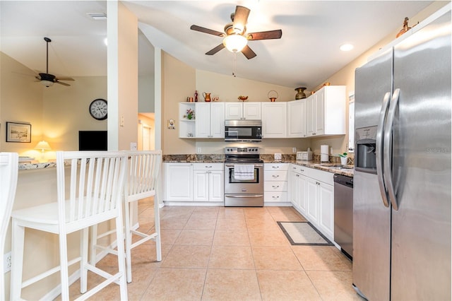 1626 Terra Ceia Bay Cir Unit 1626, Palmetto, FL 34221 - kitchen featuring stainless steel appliances, a ceiling fan, lofted ceiling, dark stone countertops, and white cabinets