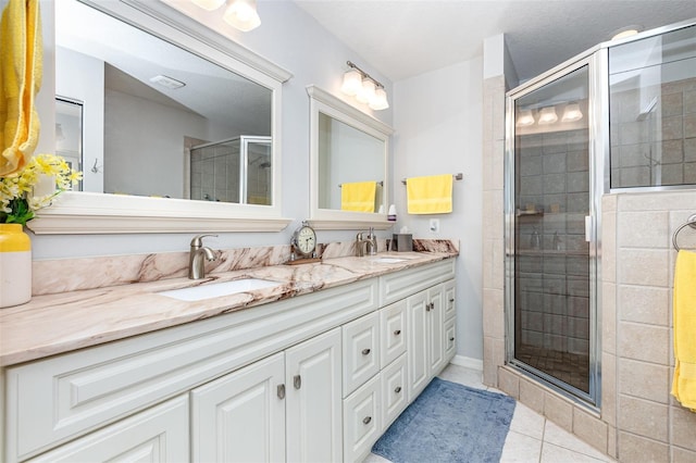 1626 Terra Ceia Bay Cir Unit 1626, Palmetto, FL 34221 - bathroom with double vanity, a shower stall, and tile patterned flooring