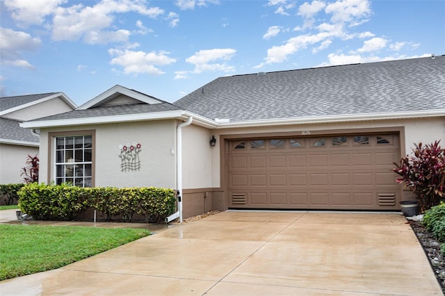 1626 Terra Ceia Bay Cir Unit 1626, Palmetto, FL 34221 - view of front facade with stucco siding, an attached garage, concrete driveway, and roof with shingles