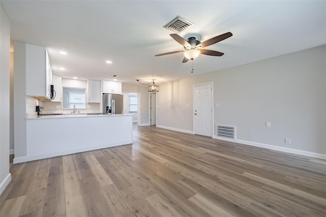 314 Circle Dr, Palm Harbor, FL 34683 - unfurnished living room featuring ceiling fan, light wood-type flooring, and recessed lighting