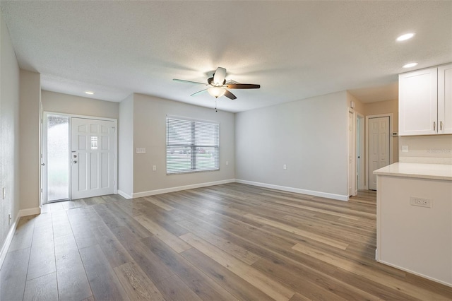314 Circle Dr, Palm Harbor, FL 34683 - unfurnished living room featuring a ceiling fan, recessed lighting, and light wood-style flooring