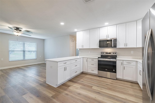 314 Circle Dr, Palm Harbor, FL 34683 - kitchen featuring stainless steel appliances, a peninsula, white cabinetry, ceiling fan, and recessed lighting