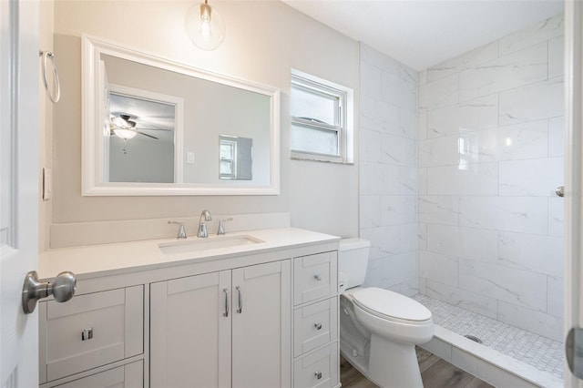 314 Circle Dr, Palm Harbor, FL 34683 - bathroom with vanity, tiled shower, and a ceiling fan