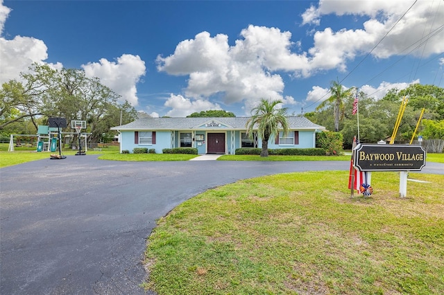 314 Circle Dr, Palm Harbor, FL 34683 - ranch-style home featuring a front lawn and asphalt driveway