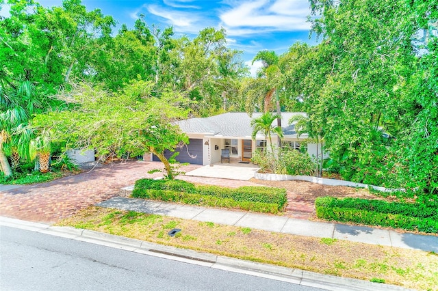 1578 Druid Rd S, Belleair, FL 33756 - view of front of property featuring driveway and a garage