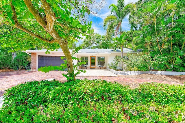 1578 Druid Rd S, Belleair, FL 33756 - rear view of property with a garage and driveway