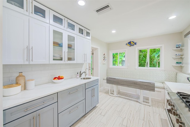 1578 Druid Rd S, Belleair, FL 33756 - kitchen featuring gray cabinetry, backsplash, recessed lighting, stainless steel range, and white cabinetry