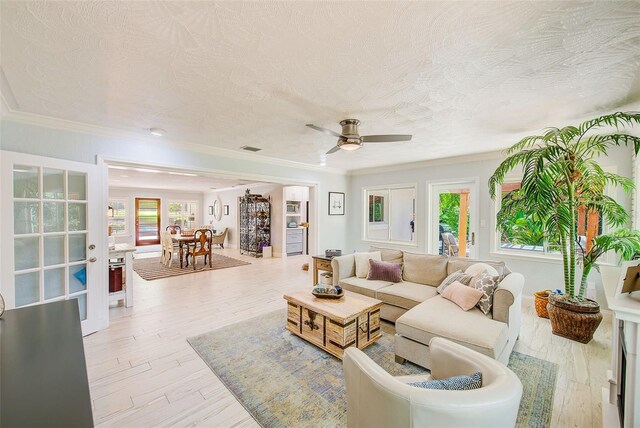 1578 Druid Rd S, Belleair, FL 33756 - living area with a ceiling fan, a textured ceiling, wood finished floors, and ornamental molding