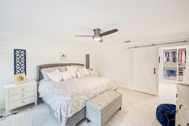 1578 Druid Rd S, Belleair, FL 33756 - bedroom with ornamental molding, a barn door, and ceiling fan