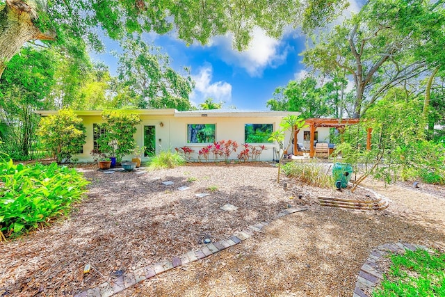 1578 Druid Rd S, Belleair, FL 33756 - view of front of house with stucco siding and a pergola