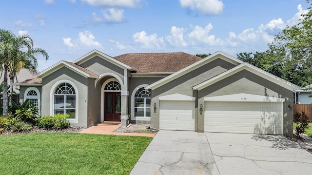9126 Cypress Keep Ln, Odessa, FL 33556 - view of front of house with a garage, stucco siding, a front yard, and concrete driveway