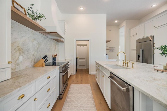 9126 Cypress Keep Ln, Odessa, FL 33556 - kitchen featuring high quality appliances, white cabinetry, light wood-type flooring, tasteful backsplash, and recessed lighting