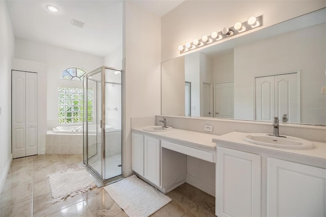 9126 Cypress Keep Ln, Odessa, FL 33556 - full bath with double vanity, a garden tub, a shower stall, and a closet