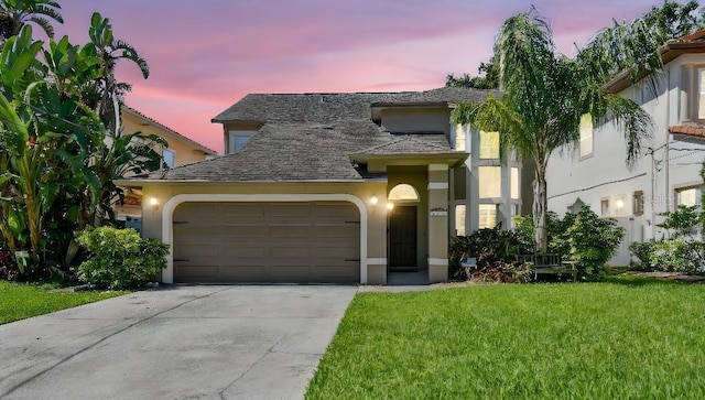3304 W Harbor View Ave, Tampa, FL 33611 - view of front facade featuring stucco siding, a garage, driveway, and a lawn