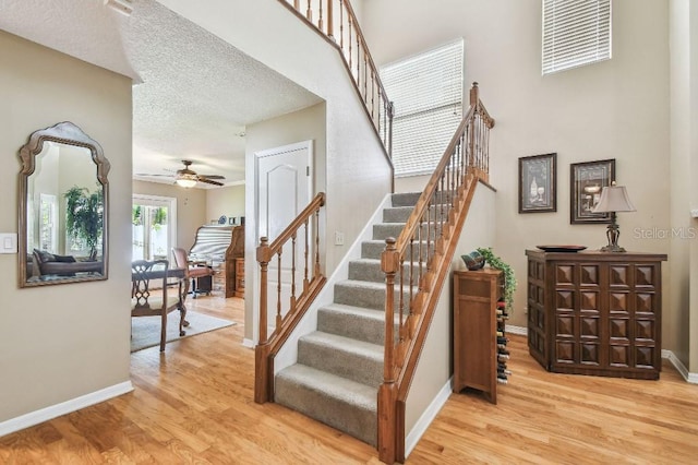 3304 W Harbor View Ave, Tampa, FL 33611 - stairs with ceiling fan, wood finished floors, and a textured ceiling