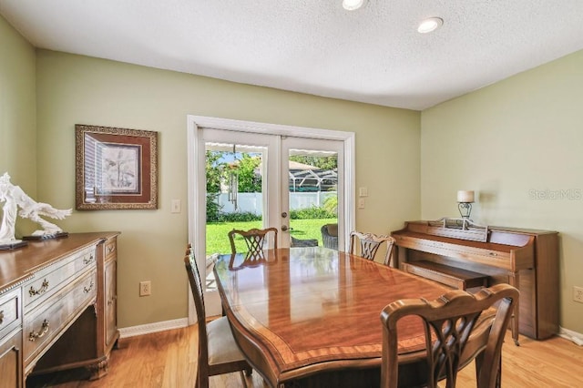 3304 W Harbor View Ave, Tampa, FL 33611 - dining room with french doors, light wood-style floors, a textured ceiling, and recessed lighting