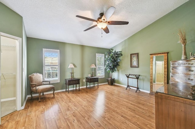 3304 W Harbor View Ave, Tampa, FL 33611 - sitting room featuring lofted ceiling, light wood-type flooring, a textured ceiling, and ceiling fan