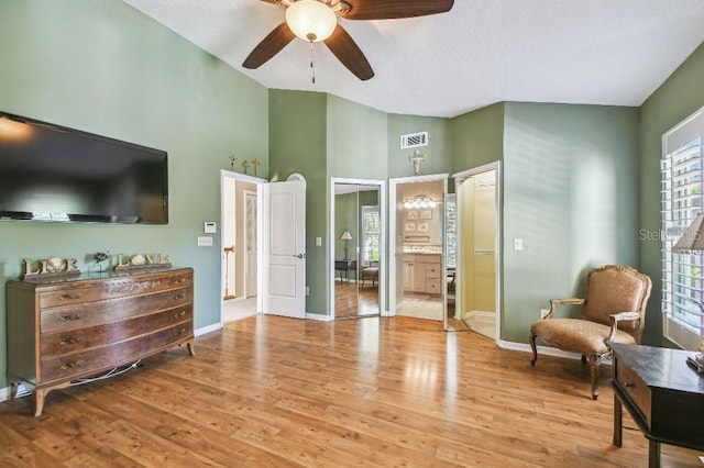 3304 W Harbor View Ave, Tampa, FL 33611 - bedroom featuring wood finished floors, high vaulted ceiling, ceiling fan, ensuite bath, and a textured ceiling