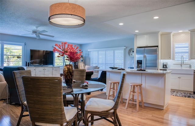 7941 58th Ave N Unit 301, Saint Petersburg, FL 33709 - dining room featuring light wood-type flooring, ceiling fan, recessed lighting, and a textured ceiling
