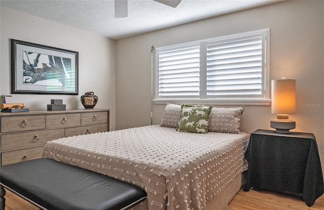 7941 58th Ave N Unit 301, Saint Petersburg, FL 33709 - bedroom featuring wood finished floors, a textured ceiling, and a ceiling fan