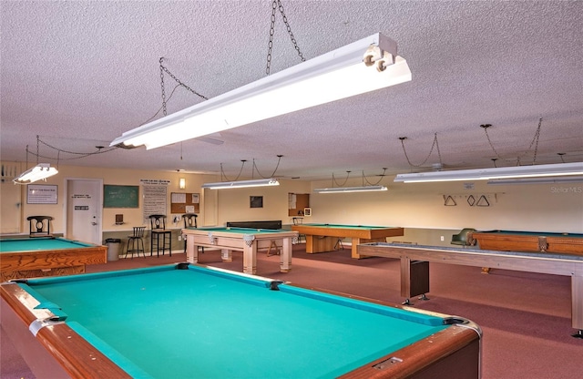 7941 58th Ave N Unit 301, Saint Petersburg, FL 33709 - playroom featuring billiards, a textured ceiling, and carpet