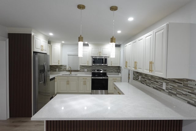 814 W 131st Ave, Tampa, FL 33612 - kitchen with appliances with stainless steel finishes, backsplash, light wood finished floors, a peninsula, and recessed lighting