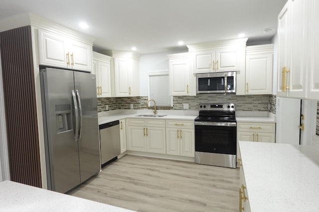 814 W 131st Ave, Tampa, FL 33612 - kitchen with appliances with stainless steel finishes, light countertops, light wood-type flooring, tasteful backsplash, and recessed lighting