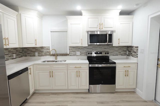 814 W 131st Ave, Tampa, FL 33612 - kitchen with stainless steel appliances, light wood-style flooring, light countertops, backsplash, and recessed lighting