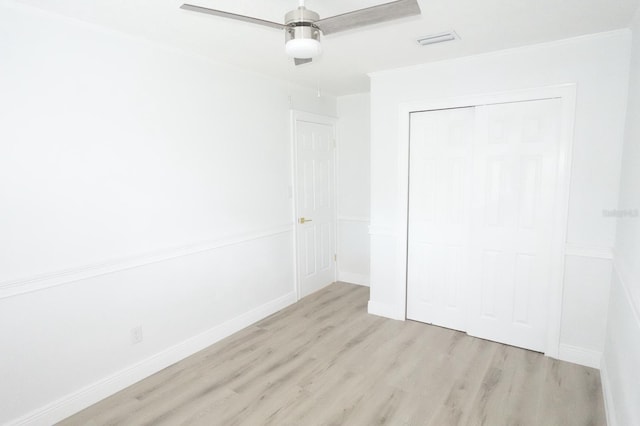 814 W 131st Ave, Tampa, FL 33612 - unfurnished bedroom with wood finished floors, ornamental molding, a closet, and a ceiling fan