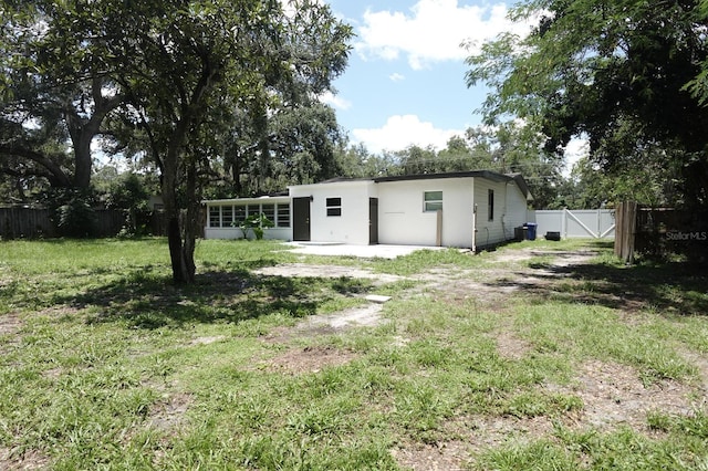 814 W 131st Ave, Tampa, FL 33612 - back of property with stucco siding and a sunroom