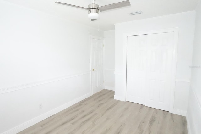 814 W 131st Ave, Tampa, FL 33612 - unfurnished bedroom featuring wood finished floors, crown molding, a closet, and a ceiling fan