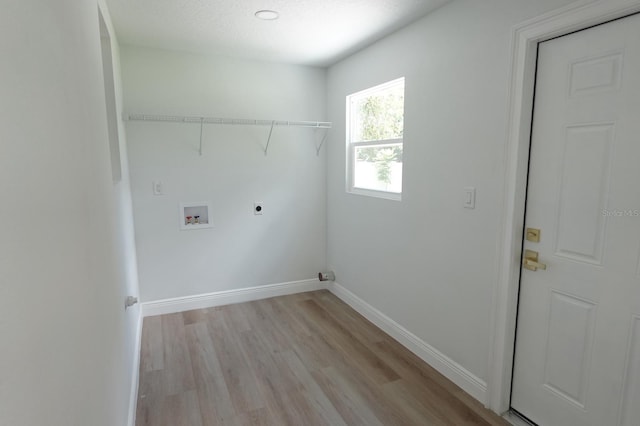 814 W 131st Ave, Tampa, FL 33612 - washroom featuring hookup for an electric dryer, light wood-style flooring, and hookup for a washing machine