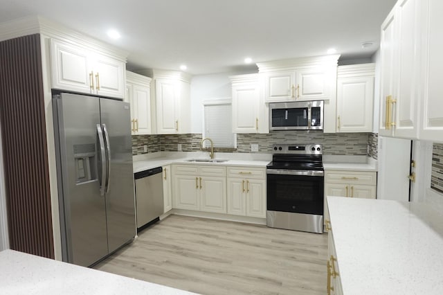 814 W 131st Ave, Tampa, FL 33612 - kitchen with appliances with stainless steel finishes, light countertops, light wood-style flooring, tasteful backsplash, and recessed lighting