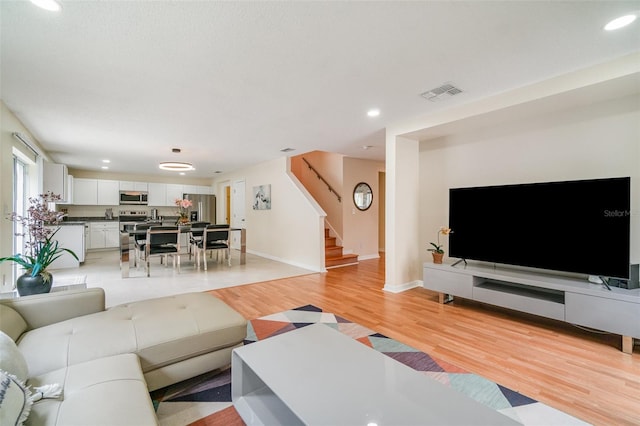 16828 N Gold Star Ct, Clermont, FL 34714 - living room featuring light wood finished floors, stairway, and recessed lighting
