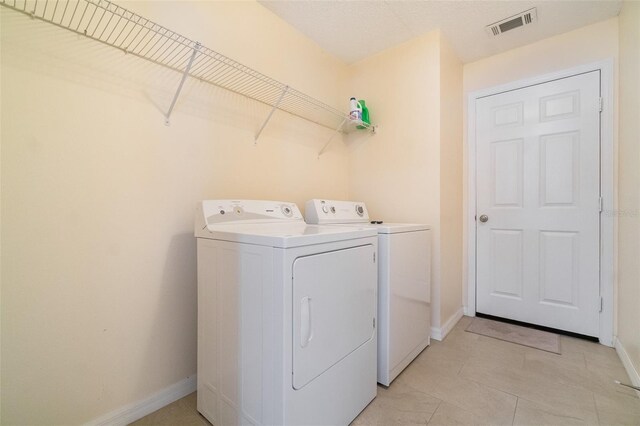 16828 N Gold Star Ct, Clermont, FL 34714 - washroom with independent washer and dryer and baseboards