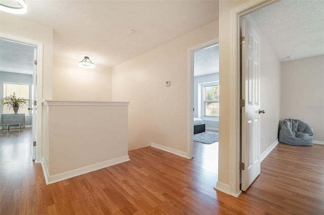 16828 N Gold Star Ct, Clermont, FL 34714 - hall with wood finished floors and a textured ceiling