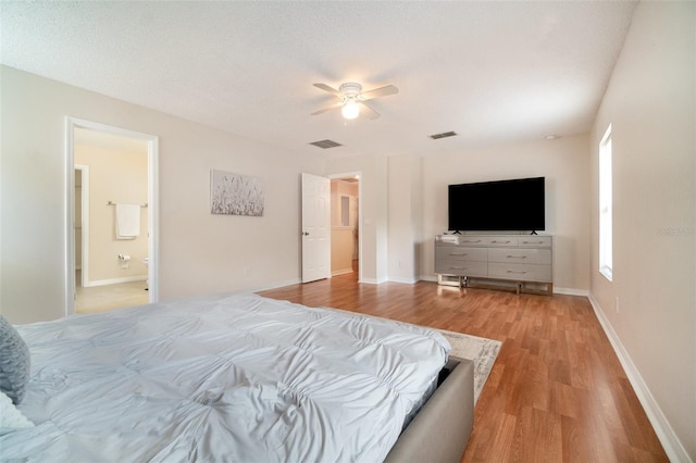 16828 N Gold Star Ct, Clermont, FL 34714 - bedroom with light wood-style flooring, a ceiling fan, and ensuite bath